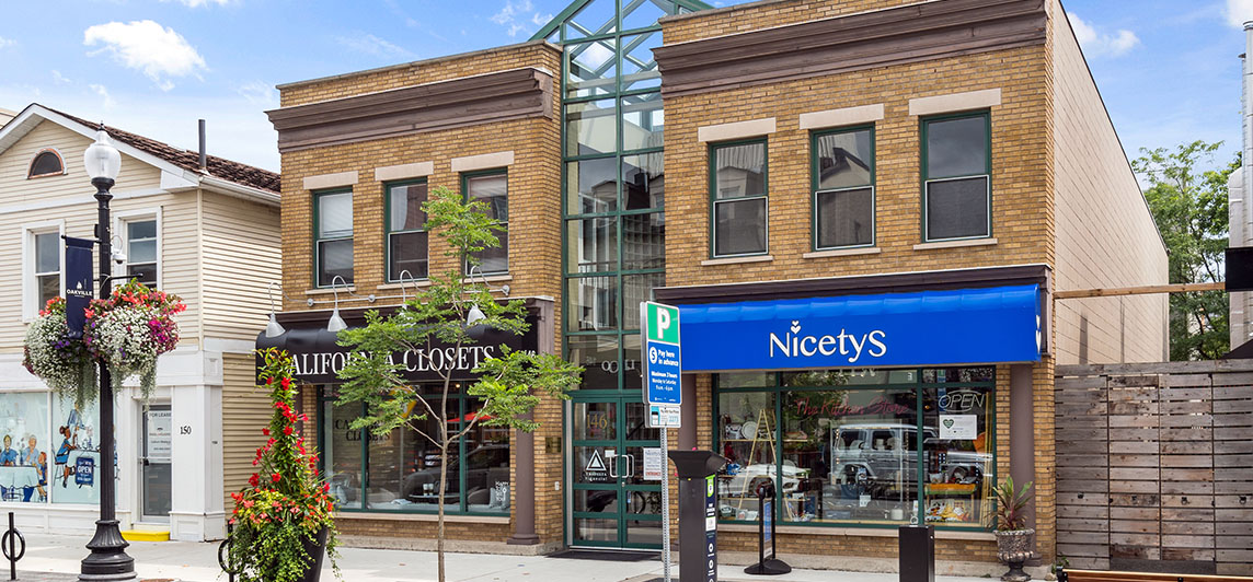 Storefront with large window and awning located at 146 Lakeshore Road East, Oakville, Ontario.