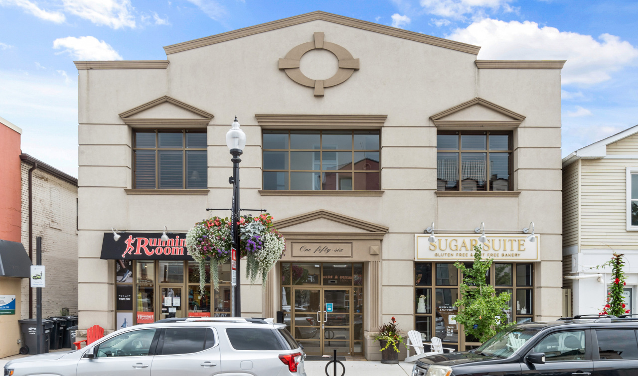 A large two-storey building with two stores located on ground level. Located at 156 Lakeshore Road East, Oakville, Ontario.